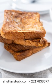 Stack Of Freshly Baked French Toast On A White Plate.