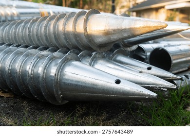 Stack of galvanized screw piles for house foundation