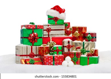 A Stack Of Gift Wrapped Christmas Presents On Snow, Isolated Against A White Background.