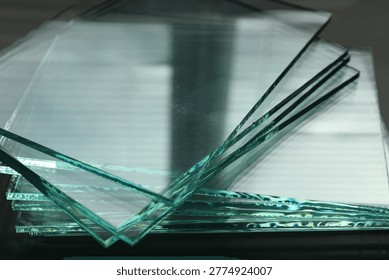 Stack of glass sheets on table, closeup