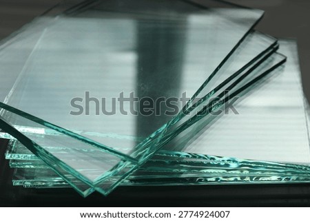 Stack of glass sheets on table, closeup