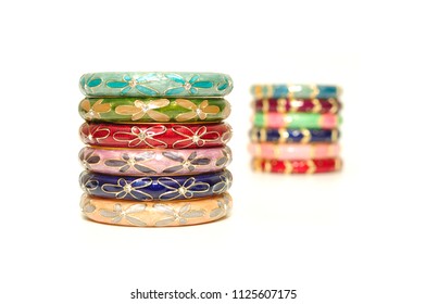 Stack of gold bangle with vivid color floral pattern and rhinestone blur isolated on white background
