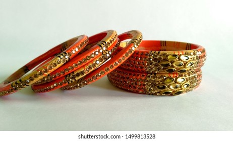 Stack of gold bangle with vivid color and rhinestone isolated on white background