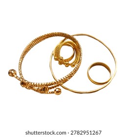 A stack of gold bangles with textured and beaded details on a white surface