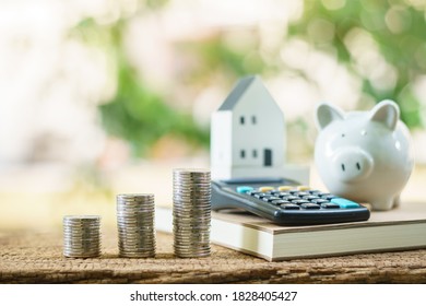 Stack gold coin with benefit from dividend and growth of value and house and calculator  and piggy bank put on the table in the backyard, Saving money buy home and Investment real estate concept. - Shutterstock ID 1828405427