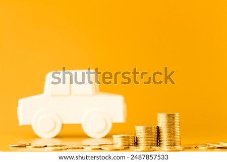 Stack gold coin and car model with growing interest on brown background, Saving money for buy a new chattel or loan business investment in the future concept.