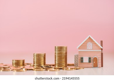 Stack Gold Coin And Home Sweet Home On The Pink Background In The Office, Loan For Real Estate Or Saving Money For Buy A New House To Family In The Future Concept.