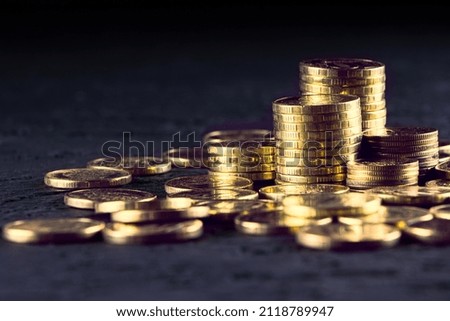 A stack of gold coins isolated on a black background.Money on a black background.Finance and money