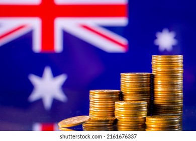 A Stack Of Gold Coins On The Background Of The Flag Of Australia . Country Economy Concept
