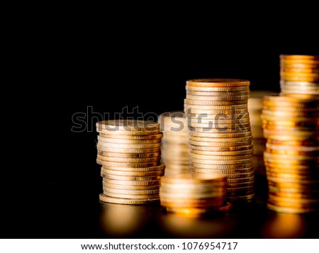 Stack of golden coins isolated on black background
