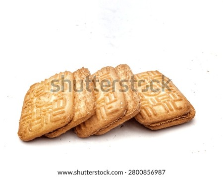 A stack of golden, crispy biscuits set against a clean white background, showcasing detailed textures and negative space suitable for food designs or advertisements
