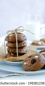 A Stack Of Gooey Chocolate Chip Cookies With A Glass Of Milk