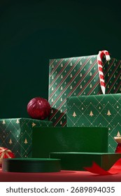 Stack of green gift boxes decorated with red ribbons and baubles. Christmas still life with elegant and joyful style. Concept of Christmas celebration decorated