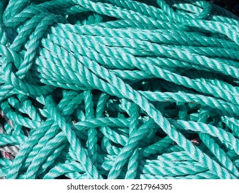 Stack Of Green Nylon Coiled And Knotted Marine Fishing Rope