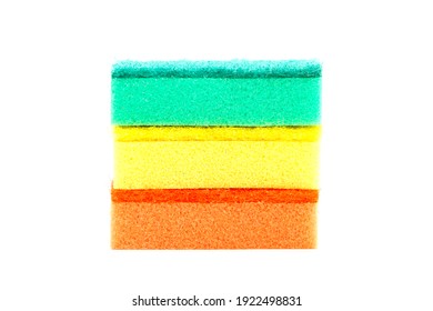 A stack of green, yellow and red spunges on a white background.
