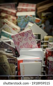 Stack of greeting cards in rack with love hearts hand drawn