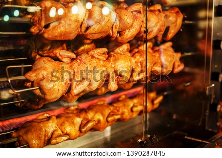 A stack of grilled chicken on a skewer fried in a commercial oven