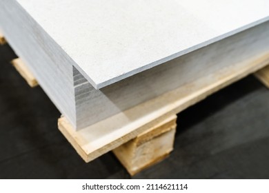 A Stack Of Gypsum Boards On A Wooden Pallet. Trade And Delivery Of Building Materials. Selective Focus. Close-up