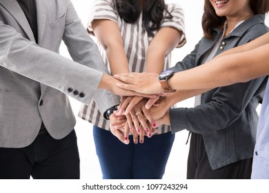 Stack hand a group of young asian business team together