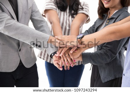 Stack hand a group of young asian business team together