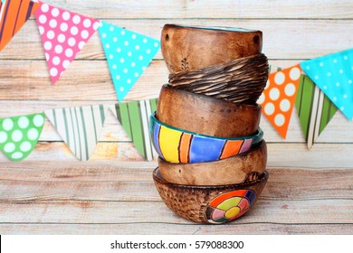 Stack of handmade multicolor six different bright ceramic pottery bowls and cups handcrafted placed vertically in one another