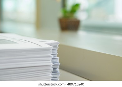 Stack Of Handout Organized For Conference On Desk At Office.