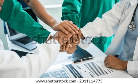 Stack of hands of International doctor team meeting hospital medical staff.