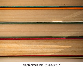 A stack of hardcover Books. Old, battered and faded hardcover books or textbooks in a bookstore or library.  The concept of 