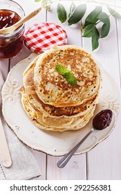 Stack Of Healthy Low Carb Oat Pancakes And Jam Over White Wooden Background