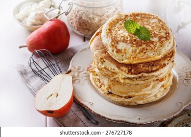 Stack Of Healthy Low Carbs Oat Pancakes Over White Wooden Background
