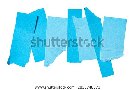 Stack or heap of blue scraps, stripes or snippets of cut out and torn paper pieces or cardboard, isolated on white background