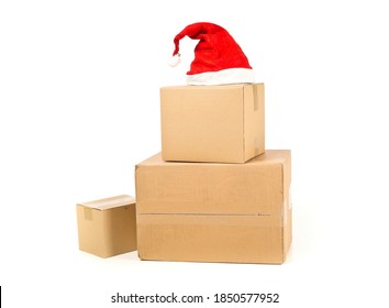 Stack or heap of brown carton cardboard boxes with red santa hat over white background, christmas shopping or online ordering concept - Powered by Shutterstock
