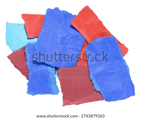 Stack or heap of colorful blue red crumpled scraps, stripes or snippets of paper or cardboard, isolated on white background