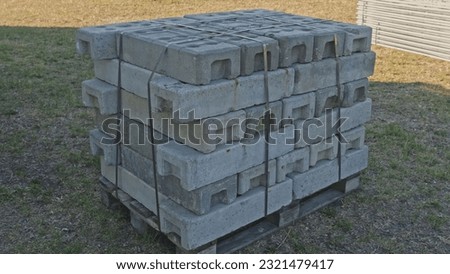 Stack of Heavy Concrete Blocks used as Counterweight for Metal Temporary Fence Sections