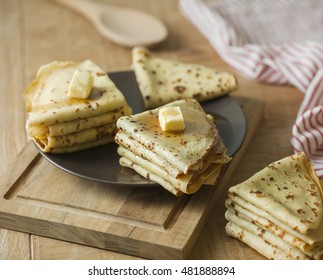 Stack of homemade pancakes with  pouring maple syrop
