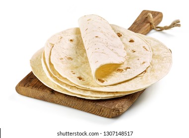 Stack Of Homemade Wheat Flour Tortilla On Wooden Cutting Board Isolated On White Background