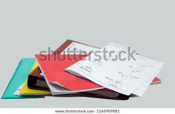 stack of homework, mathematics task, books,\
file, booklet and white\
background