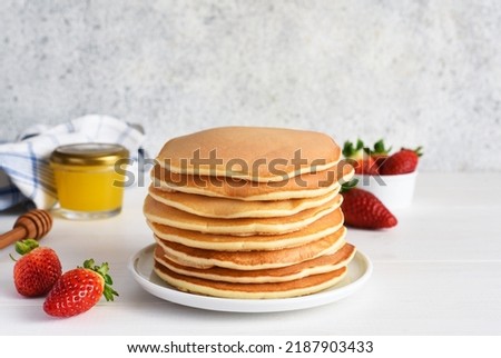 Stack of honey pancakes, homemade strawberry pancakes for breakfast