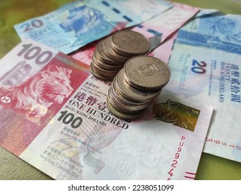 Stack of Hong Kong 5 dollar coins on Hong Kong dollar banknotes - Shutterstock ID 2238051099