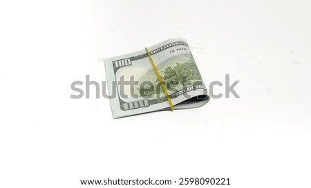 Stack of Hundred Dollar Bills isolated on white background. A stack of US dollar bills, tied with a brown rubber band.
