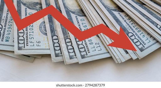 Stack of hundred-dollar bills with red downward arrow. Arrow implies decline or loss in financial value. Visual metaphor for economic downturn or market drop. Commonly used for business, finance