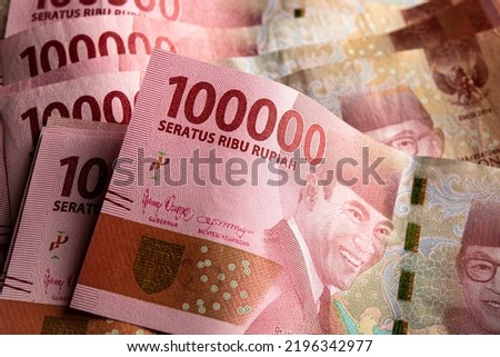 Stack of Indonesian one hundred thousand rupiah banknotes.  100000 IDR