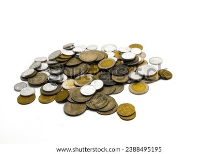stack of Indonesian rupiah coins of various denominations on a white background. Indonesian coins. Concept of finance, investment, economy, business and success.