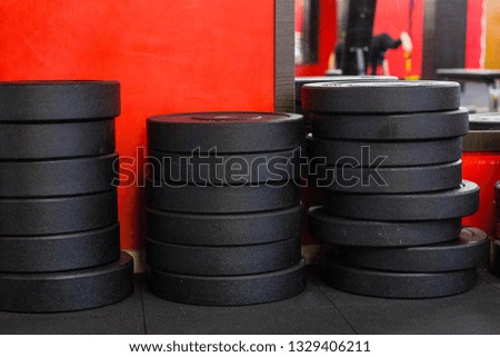 A stack of iron disc weights in a gym