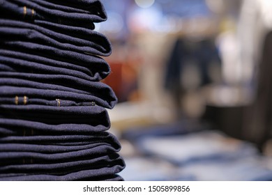 stack of jeans or denim with blurred background and copy space. concept for typography and advertisement of fashion, shopping and business.