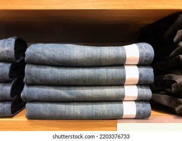 Stack of jeans on shelf. Concept of buy , sell , shopping and jeans fashion 