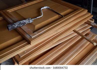 Stack Of Kitchen Cabinets With Paint Roller Handle On Top