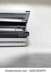 stack of laptops on a gray background, on the table, laptop computer, tablet, business, work, remote work, freelance.