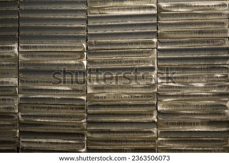stack of laser cut steel billets - closeup texture and background.