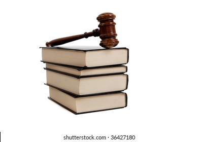 A Stack Of Legal Books And A Wooden Gavel On A White Background